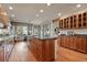 Bright kitchen boasts wood cabinets, granite countertops, stainless steel appliances, and a breakfast nook with scenic views at 9041 Eastridge Rd, Golden, CO 80403
