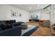 Comfortable living room with a plush blue sectional, statement rug, modern furniture, and a wall-mounted television at 9041 Eastridge Rd, Golden, CO 80403