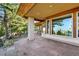 Spacious stone patio featuring wood beams and large windows with scenic views of the surrounding landscape at 9041 Eastridge Rd, Golden, CO 80403