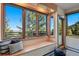Bright window seat with scenic views and cozy cushions, an ideal spot for relaxation and enjoying the natural surroundings at 9041 Eastridge Rd, Golden, CO 80403