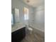 Bathroom features a modern vanity, white tile shower, and stylish fixtures at 2176 S Haleyville Way, Aurora, CO 80018