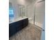 Bathroom features a modern vanity, double sinks, and a spacious shower with a glass enclosure at 2176 S Haleyville Way, Aurora, CO 80018