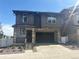 Charming two-story home with a stone facade, covered porch, and a spacious two-car garage at 2176 S Haleyville Way, Aurora, CO 80018