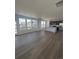 Sunlit open-concept living area with hardwood floors and large windows, open to the island kitchen at 2176 S Haleyville Way, Aurora, CO 80018