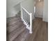 Interior staircase with white trim and black railing, leading to the upper level of the home at 2176 S Haleyville Way, Aurora, CO 80018