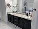 Dual sink vanity with a marble countertop and black cabinets at 5724 S Rome St, Aurora, CO 80015