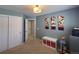 This blue-walled bedroom has closet space and playful artwork, and is a comfortable, carpeted space at 5724 S Rome St, Aurora, CO 80015