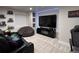 Basement entertainment room with modern lighting, large television, comfortable seating and gaming decor at 5724 S Rome St, Aurora, CO 80015