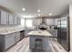 Spacious kitchen with gray cabinets, stainless steel appliances, and a center island at 5724 S Rome St, Aurora, CO 80015