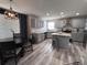 Modern kitchen with gray cabinets, stainless steel appliances, and an eat-in dining area at 5724 S Rome St, Aurora, CO 80015
