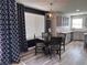 Modern kitchen with gray cabinets, stainless steel appliances, and an eat-in dining area at 5724 S Rome St, Aurora, CO 80015