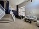 Spacious living room with soaring ceilings, large windows, neutral decor, and elegant furnishings at 5724 S Rome St, Aurora, CO 80015