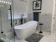 This main bathroom features a soaking tub, modern fixtures, and stylish tile work at 5724 S Rome St, Aurora, CO 80015