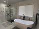 This main bathroom features a soaking tub, modern fixtures, and stylish tile work at 5724 S Rome St, Aurora, CO 80015