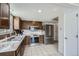 This kitchen features sleek stainless steel appliances and white tile floors at 9630 W 104Th Ave, Broomfield, CO 80021