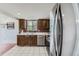 This kitchen features stainless steel appliances and a brick accent wall at 9630 W 104Th Ave, Broomfield, CO 80021