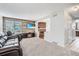 Inviting living room featuring a decorative fireplace, plush carpeting, and ample natural light at 9630 W 104Th Ave, Broomfield, CO 80021