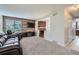Cozy living room with a wood accent wall, fireplace, and plush carpet at 9630 W 104Th Ave, Broomfield, CO 80021