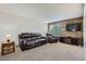 Comfortable living room with carpet, leather sofa set, and a TV stand at 9630 W 104Th Ave, Broomfield, CO 80021