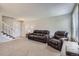 Open living room featuring carpet, and a staircase leading to the upper level at 9630 W 104Th Ave, Broomfield, CO 80021