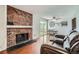 Inviting living room with a brick fireplace and dining area, perfect for gatherings at 9630 W 104Th Ave, Broomfield, CO 80021