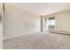 Bedroom with neutral carpeting, sliding door to balcony, and city view at 1200 N Humboldt St # 1103, Denver, CO 80218