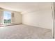 Bedroom with neutral carpeting and large window with city view at 1200 N Humboldt St # 1103, Denver, CO 80218