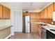 Bright kitchen features wood cabinets, stainless steel appliances, and a pantry at 1200 N Humboldt St # 1103, Denver, CO 80218