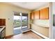 Kitchen with wood cabinets, access to balcony, and city views at 1200 N Humboldt St # 1103, Denver, CO 80218