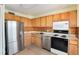 Kitchen boasts wood cabinets and stainless steel appliances at 1200 N Humboldt St # 1103, Denver, CO 80218