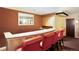 Community wet bar with granite countertop and red barstools at 1200 N Humboldt St # 1103, Denver, CO 80218