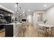 Open concept living and dining area with breakfast bar, modern finishes, and light wood-look floors at 23630 E 5Th Pl, Aurora, CO 80018