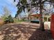 Expansive backyard featuring a patio with pergola, mature trees, and lush landscaping at 3281 Vivian Dr, Wheat Ridge, CO 80033