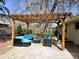 Outdoor patio area with a wooden pergola and comfortable seating, perfect for entertaining or relaxing at 3281 Vivian Dr, Wheat Ridge, CO 80033