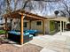 Inviting patio with pergola, stylish outdoor furniture, and views of the home's exterior at 3281 Vivian Dr, Wheat Ridge, CO 80033