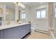 Stylish bathroom with double vanity, modern fixtures, and a window for natural light at 3281 Vivian Dr, Wheat Ridge, CO 80033