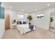 Bright bedroom with white walls, modern furnishings, and large windows, filled with natural light at 3281 Vivian Dr, Wheat Ridge, CO 80033