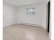 Bright bedroom featuring a window, hardwood floors, and a closet for ample storage at 3281 Vivian Dr, Wheat Ridge, CO 80033