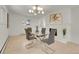 Elegant dining room featuring modern chandelier, fireplace and glass table with seating for four at 3281 Vivian Dr, Wheat Ridge, CO 80033