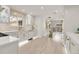 Bright kitchen features white cabinetry, modern countertops, and stainless steel appliances with gold hardware at 3281 Vivian Dr, Wheat Ridge, CO 80033
