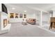 Spacious living room featuring plush carpeting, modern furniture, and a cozy fireplace at 3281 Vivian Dr, Wheat Ridge, CO 80033