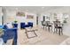 Open-concept living room with modern furnishings, stylish decor, and light hardwood floors at 3281 Vivian Dr, Wheat Ridge, CO 80033