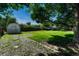 Backyard with mature trees, storage shed, and fenced perimeter at 7479 Pierce St, Arvada, CO 80003