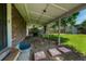 Backyard with a covered patio and a partially fenced-in yard featuring mature trees and a storage shed at 7479 Pierce St, Arvada, CO 80003