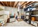 Basement features concrete floors and exposed ceilings with an unfinished room for storage and utilities at 7479 Pierce St, Arvada, CO 80003