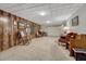 Spacious basement featuring carpet floors, wood paneled accent wall, and a drop ceiling with recessed lights at 7479 Pierce St, Arvada, CO 80003