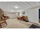 Large basement with carpet flooring, drop ceiling, wood paneled accent wall, and open space for entertaining at 7479 Pierce St, Arvada, CO 80003