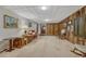 This basement features wood paneling, carpet flooring, a storage room, and ample space at 7479 Pierce St, Arvada, CO 80003