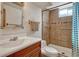 Bathroom featuring a single vanity, tiled walk-in shower, modern fixtures, and a neutral color palette at 7479 Pierce St, Arvada, CO 80003