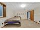 Bedroom featuring carpet floors, window, bed, and an open doorway to additional space in the home at 7479 Pierce St, Arvada, CO 80003